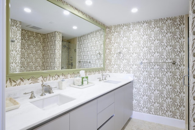 bathroom with walk in shower, tile floors, and dual vanity