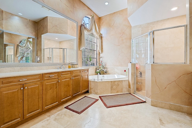 bathroom with vanity and separate shower and tub