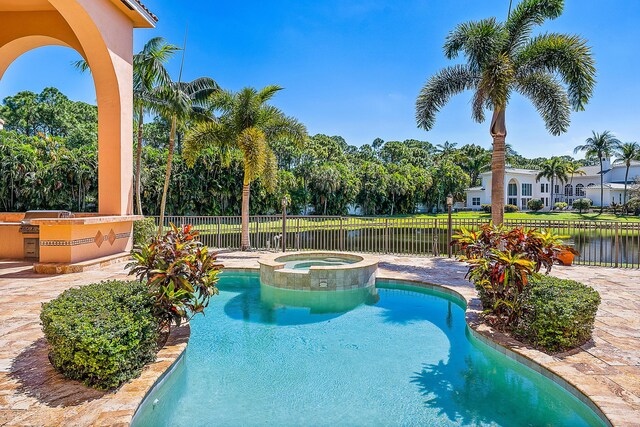 view of pool featuring a patio and an in ground hot tub