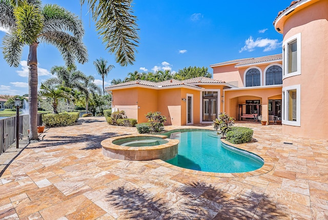 view of swimming pool featuring a patio area and an in ground hot tub