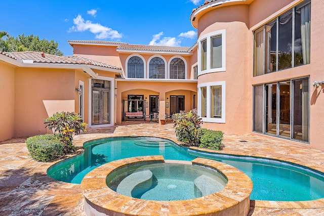 view of swimming pool with a patio area and an in ground hot tub