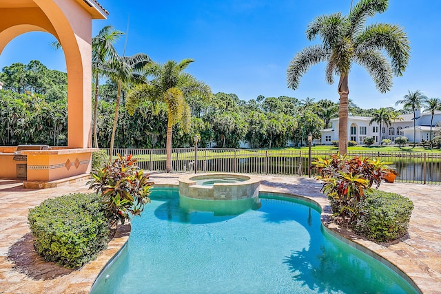 view of pool with an in ground hot tub