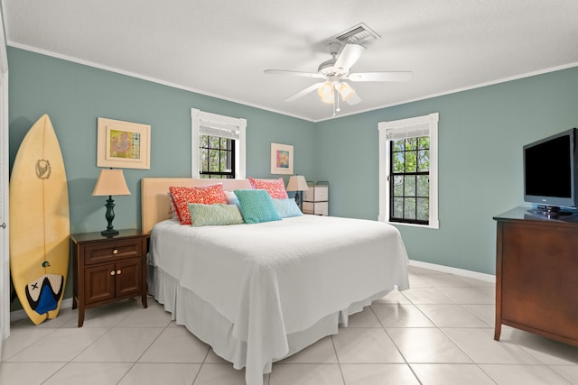 bedroom featuring ceiling fan, light tile patterned floors, and crown molding