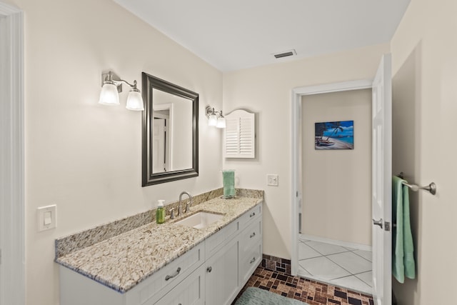 bathroom featuring tile patterned flooring and vanity