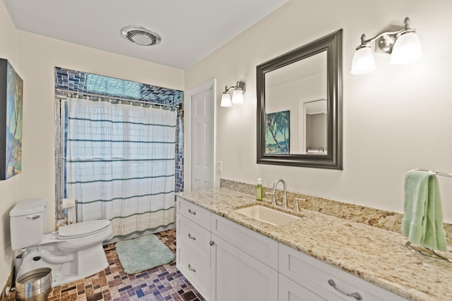 bathroom with tile patterned floors, vanity, and toilet