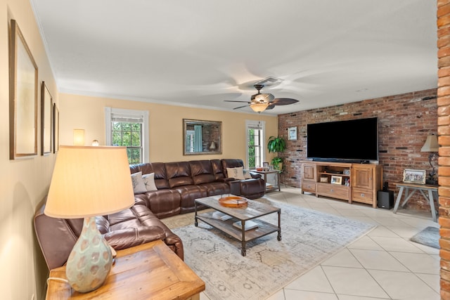 living room featuring brick wall, ceiling fan, light tile patterned floors, and crown molding