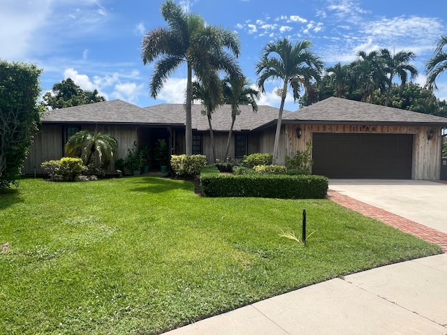 single story home with a front lawn and a garage