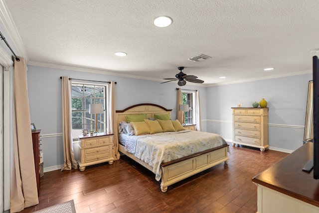 bedroom with a textured ceiling, ceiling fan, dark hardwood / wood-style flooring, and crown molding