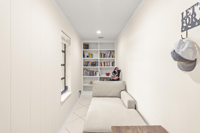 living area featuring built in features, crown molding, and light tile patterned floors