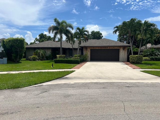 ranch-style home with a garage and a front yard