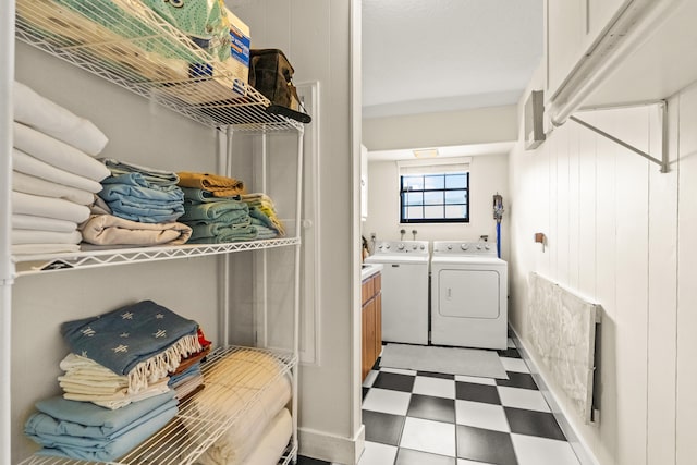 clothes washing area with washer and clothes dryer and tile patterned floors