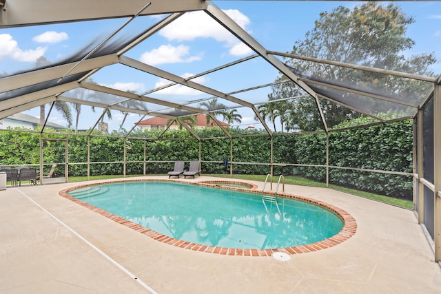 view of swimming pool featuring a patio area, a lanai, and an in ground hot tub