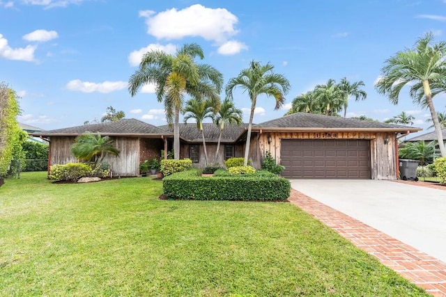 ranch-style home with a garage and a front yard