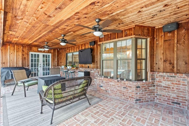 interior space with ceiling fan and french doors