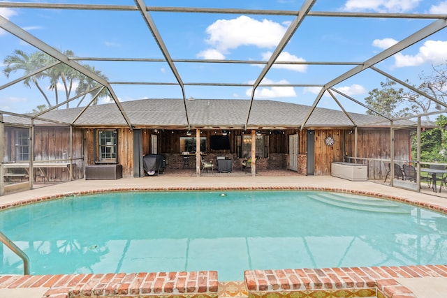 view of pool featuring a grill, a patio area, and a lanai