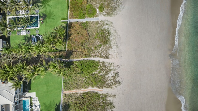 drone / aerial view featuring a water view and a beach view