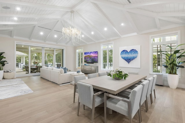 dining room with high vaulted ceiling, beam ceiling, light hardwood / wood-style floors, and a chandelier