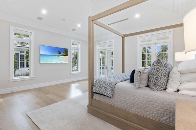 bedroom with multiple windows, wood ceiling, light hardwood / wood-style flooring, and french doors