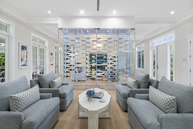 living room with crown molding and light hardwood / wood-style floors