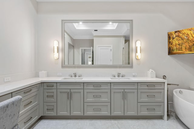 bathroom with crown molding, vanity, and a bathtub