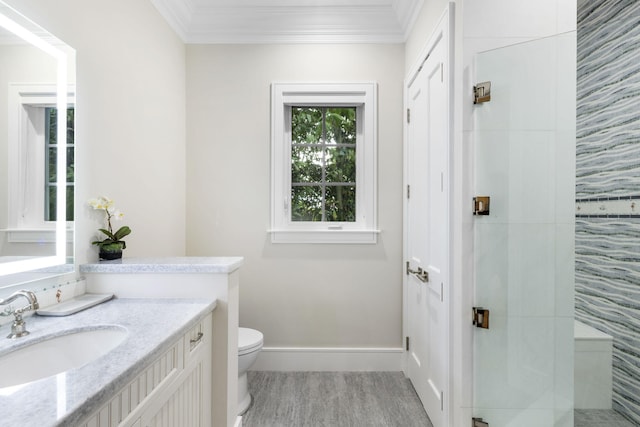 bathroom featuring ornamental molding, vanity, hardwood / wood-style floors, and toilet