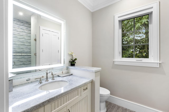 bathroom featuring hardwood / wood-style floors, vanity, crown molding, and toilet