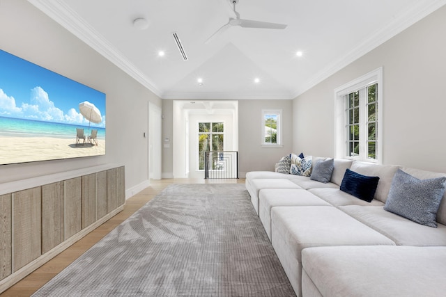 living room with lofted ceiling, ornamental molding, ceiling fan, and light hardwood / wood-style flooring