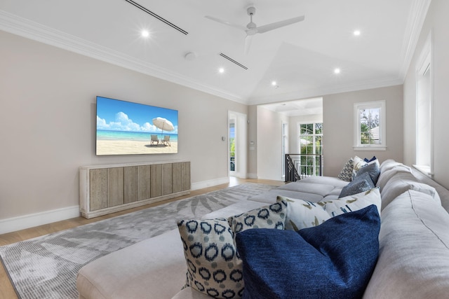 living room with light hardwood / wood-style flooring, lofted ceiling, ceiling fan, and ornamental molding