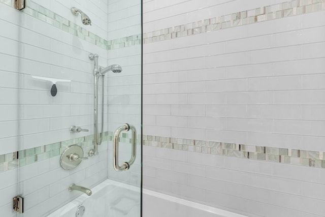 bathroom featuring shower / bath combination with glass door