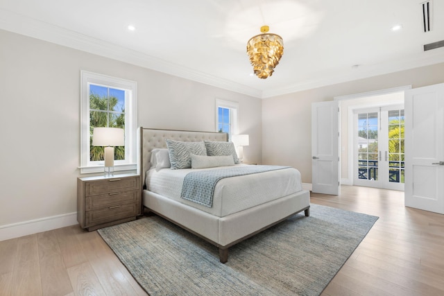 bedroom with light wood-type flooring, multiple windows, french doors, and crown molding