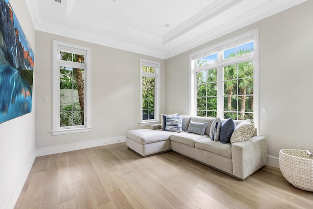 living room with light hardwood / wood-style floors and ornamental molding