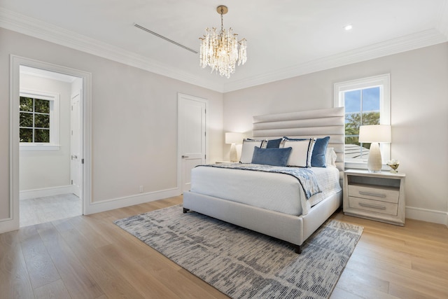 bedroom featuring light hardwood / wood-style flooring, a chandelier, and crown molding