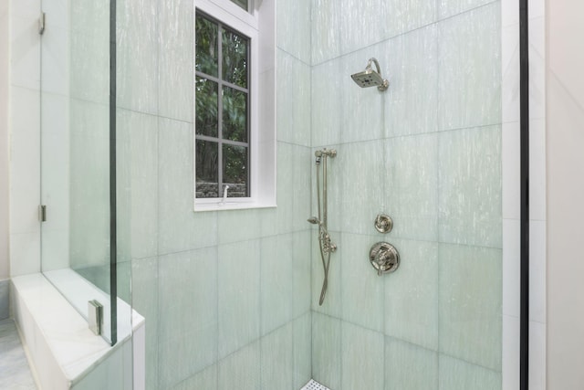 bathroom with a tile shower