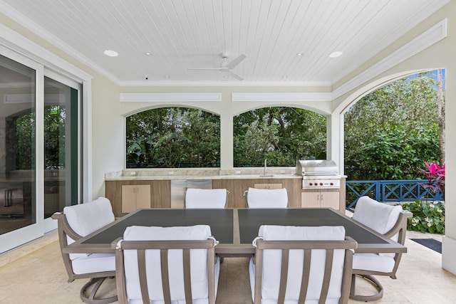 view of patio with area for grilling and ceiling fan