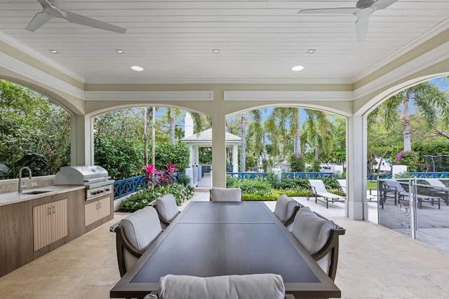 view of patio / terrace with area for grilling, ceiling fan, a grill, and sink