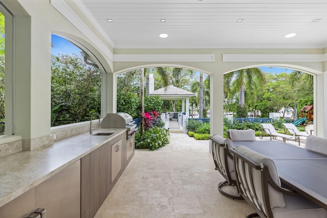 view of patio / terrace with a gazebo, grilling area, and sink