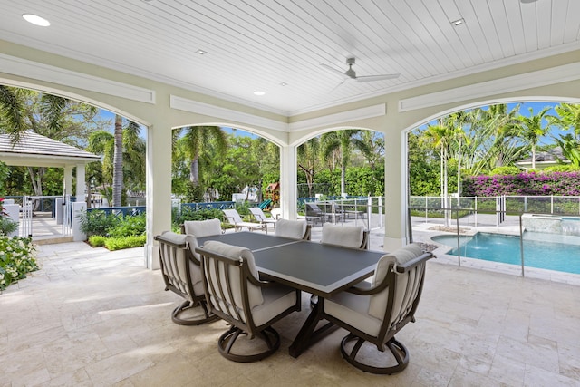 view of patio featuring pool water feature, a fenced in pool, and ceiling fan