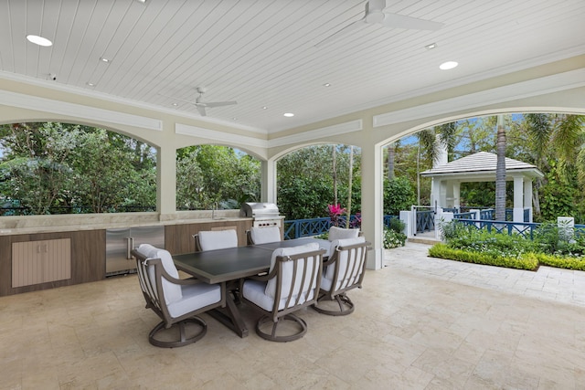 sunroom / solarium featuring wooden ceiling and ceiling fan