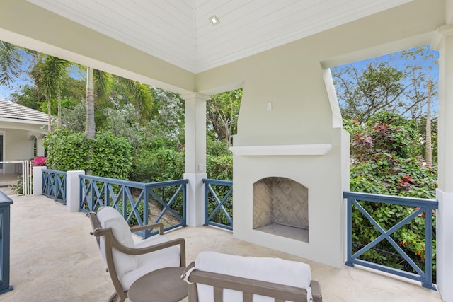 view of patio with an outdoor fireplace