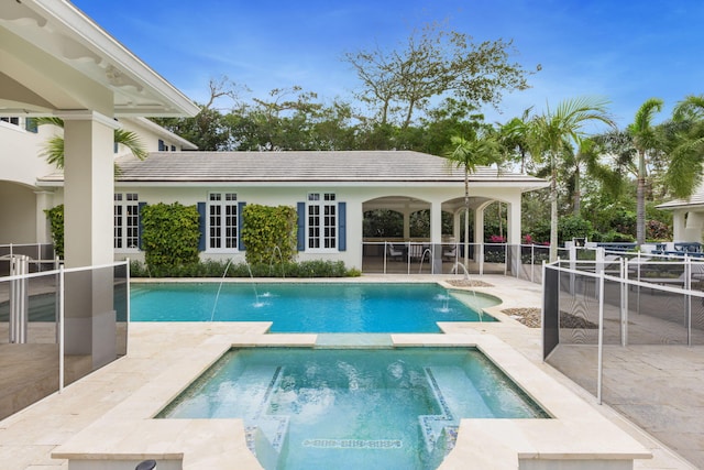 view of pool featuring pool water feature, an in ground hot tub, and a patio area