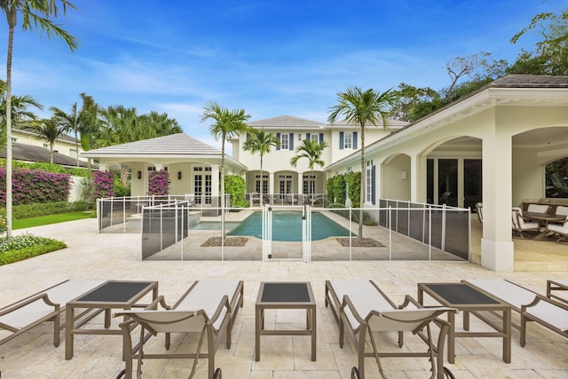 view of pool with french doors and a patio area