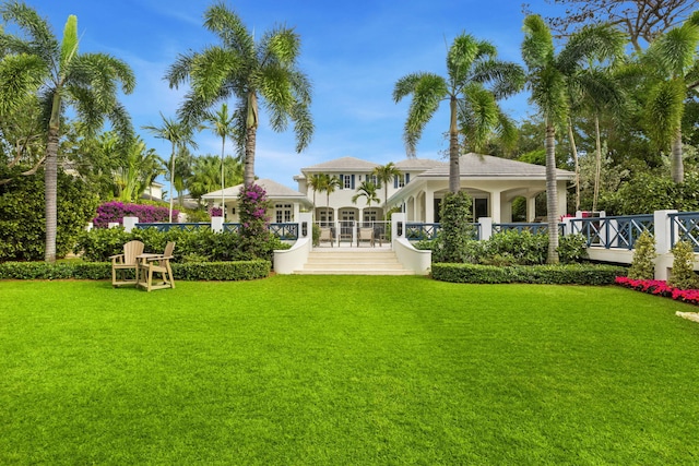 back of house with a lawn