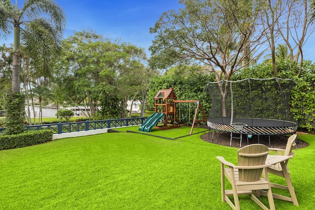 view of yard featuring a trampoline and a playground