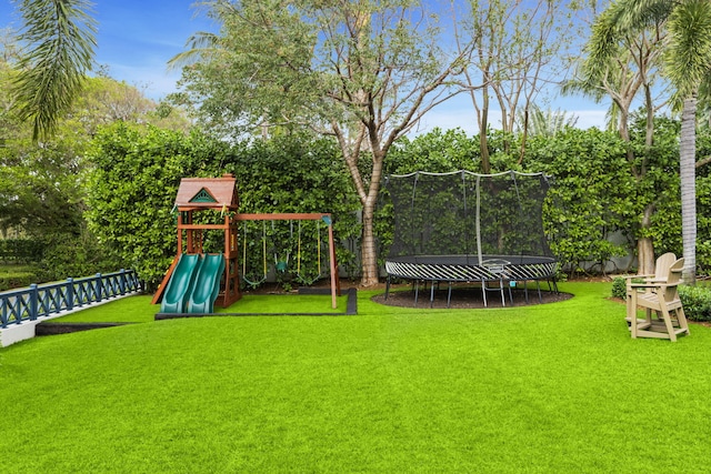 view of yard with a trampoline and a playground