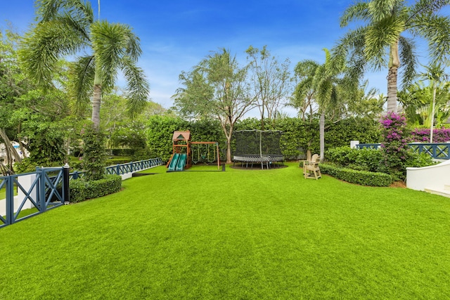 view of yard featuring a playground and a trampoline