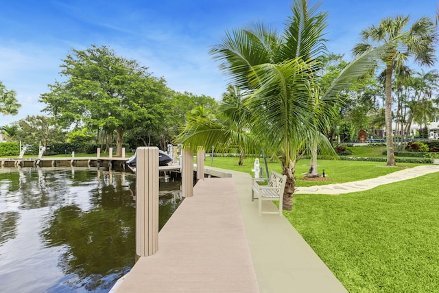 view of property's community featuring a lawn and a water view