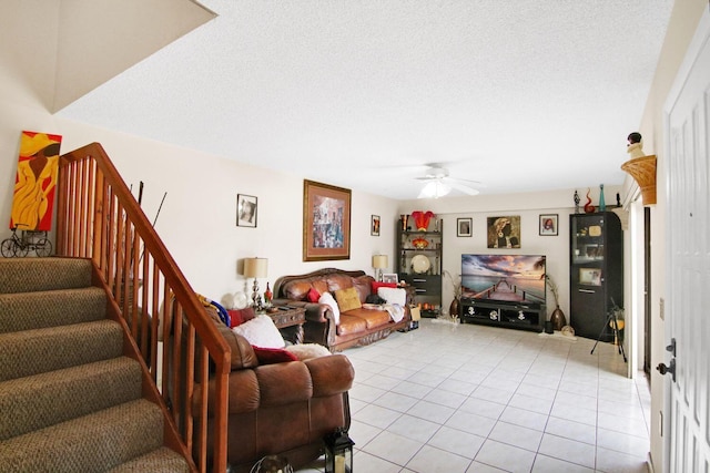 tiled living room featuring a textured ceiling and ceiling fan