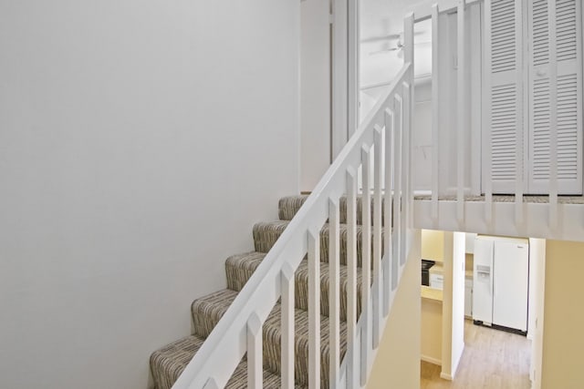 staircase featuring light hardwood / wood-style floors