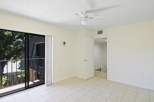 tiled spare room with a textured ceiling, a healthy amount of sunlight, and ceiling fan