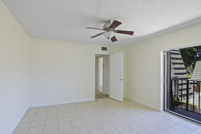 tiled empty room with plenty of natural light, a textured ceiling, and ceiling fan